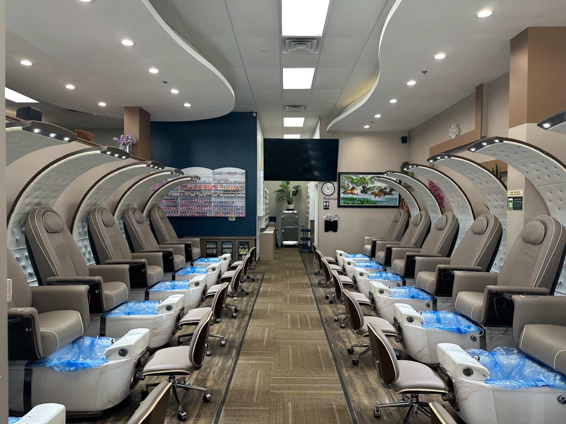 Interior of Sue's Nails & Spa — marble manicure tables and blush velvet chairs