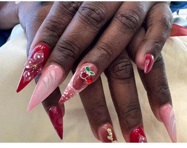 Red and blush stiletto nails with rhinestone cherry art
