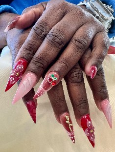 Red stiletto nails with sculpted floral art